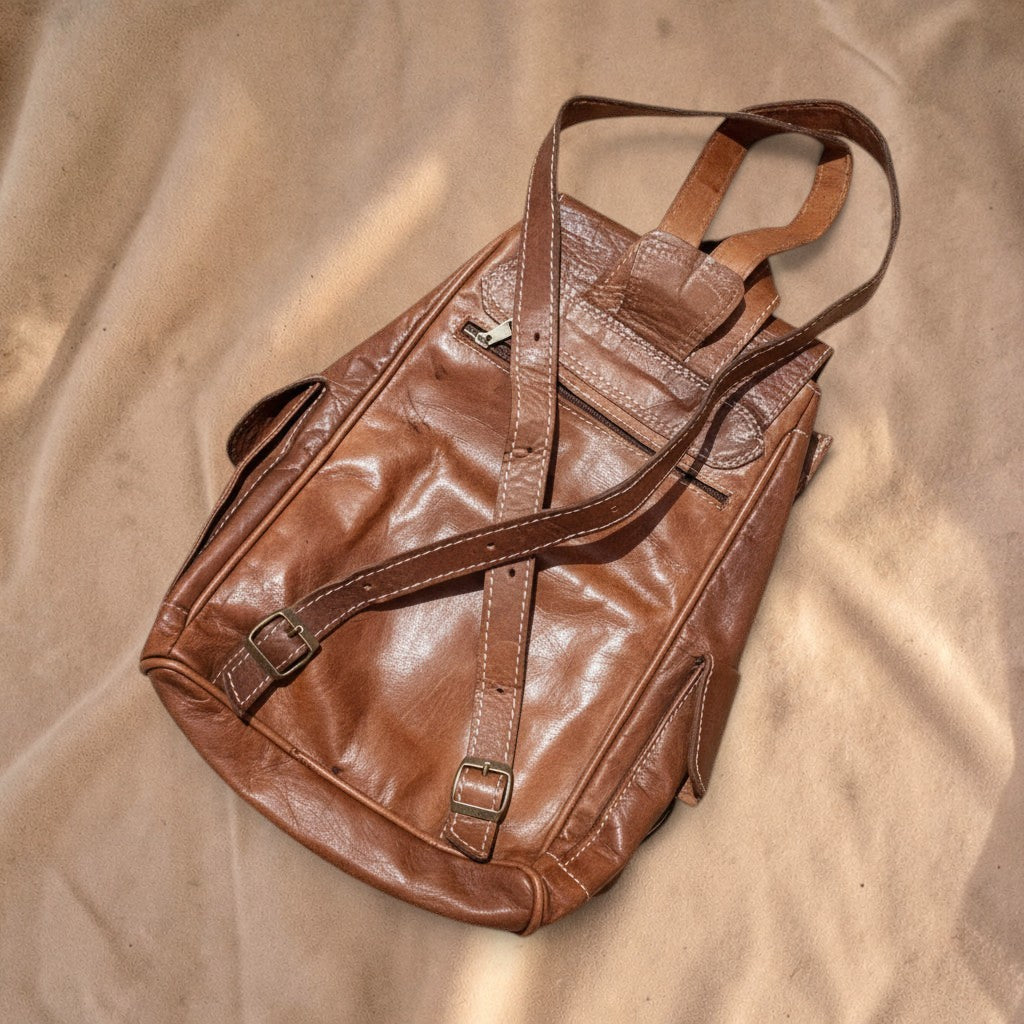 Valentina brown leather Trail backpack with adjustable straps and multiple front zipper pockets for daily use.