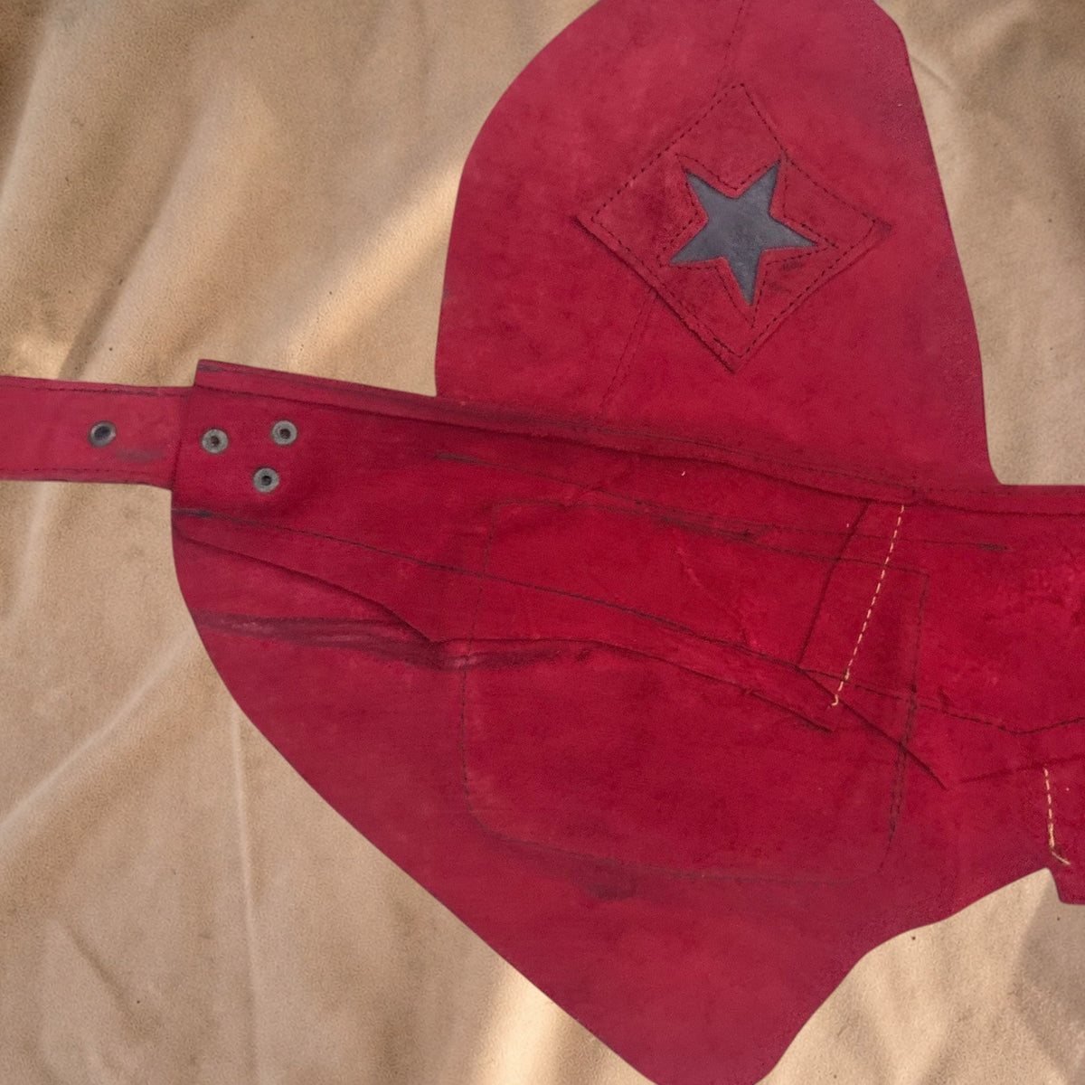 Valentina Firelight red suede waist bag with an asymmetrical flap, star detail, and adjustable strap.
