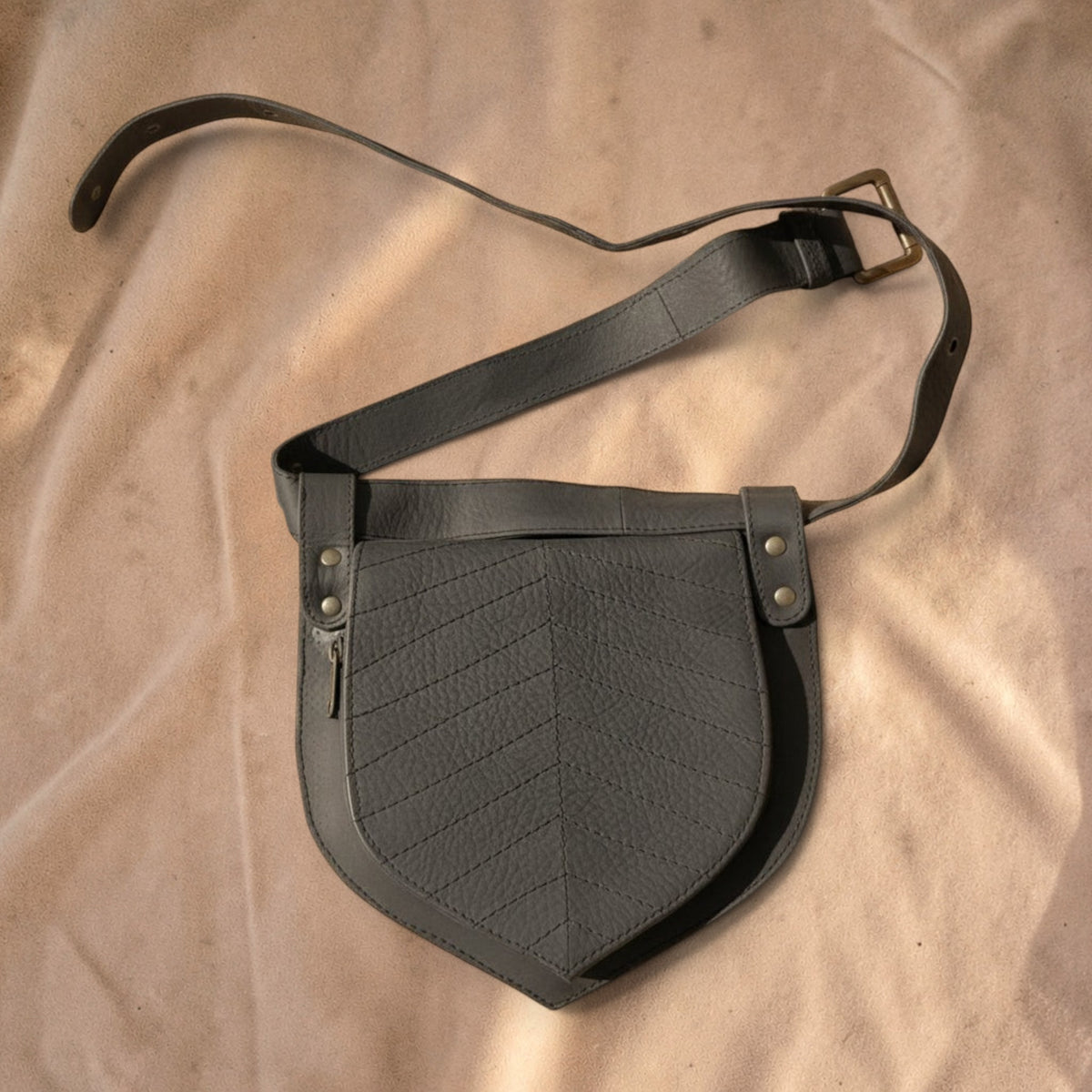 Valentina leaf-shaped grey leather fanny pack with adjustable strap and decorative stitched vein pattern