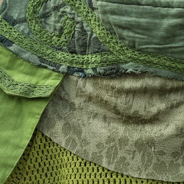 Valentina Moss Veil skirt featuring layered moss green fabrics, textured open weave details, and organic patterns.
