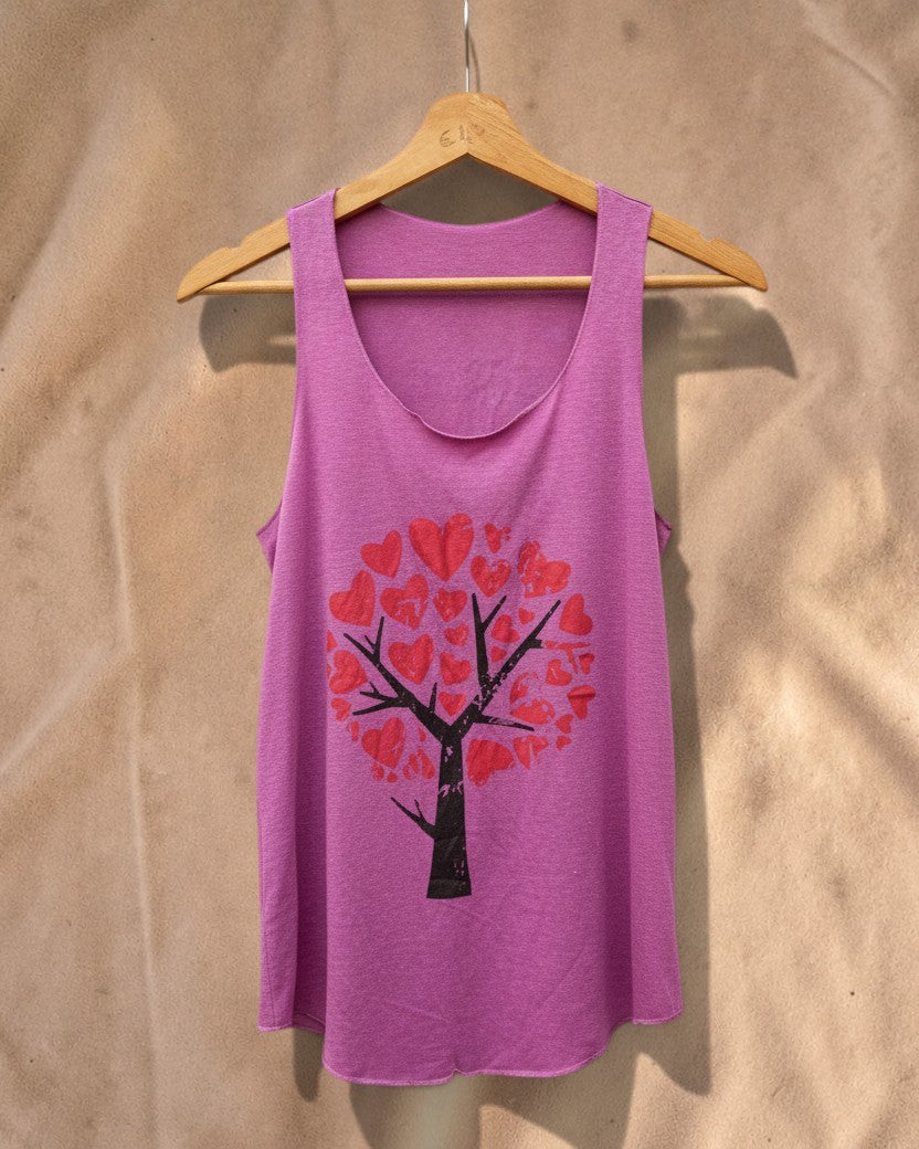 Valentina pink tank top with a black tree graphic featuring red heart-shaped leaves on a wooden hanger
