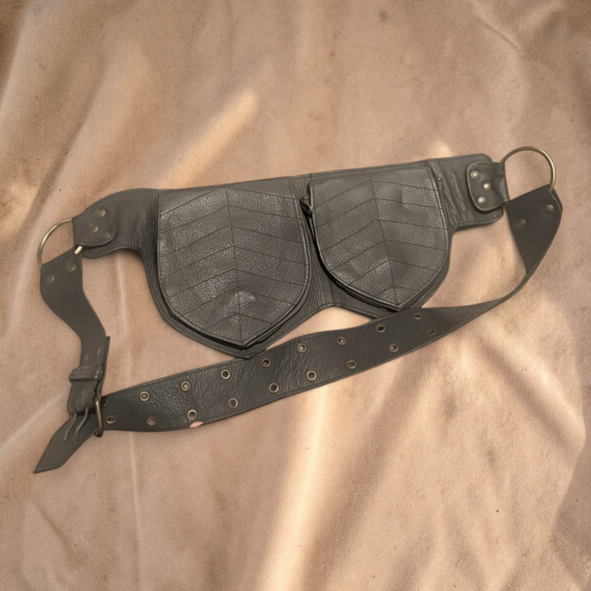 Valentina Twin Leaf leather fanny pack in dark grey with two leaf-shaped compartments and an adjustable strap.