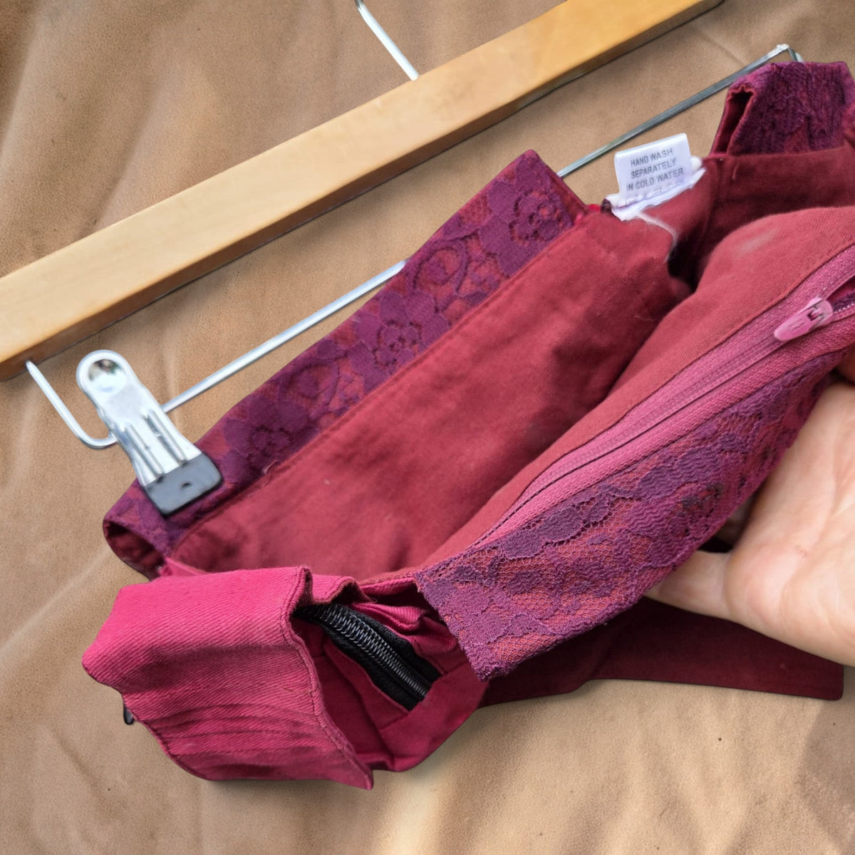 Valentina Wild Berry fanny pack in deep red fabric with intricate lace trim details on the flap and zipper closure.