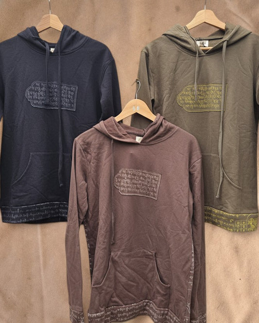 Valentina cotton hoodies in black, brown, and olive green with traditional Nepalese script prints and kangaroo pockets.