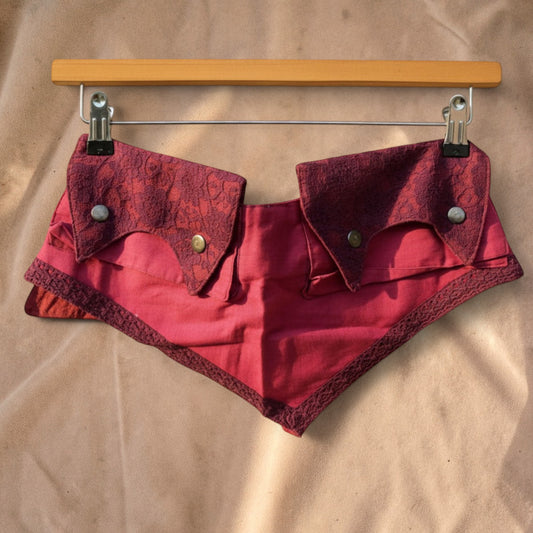 Valentina Wild Berry fanny pack in deep berry red with intricate lace flap details and brass button closures.